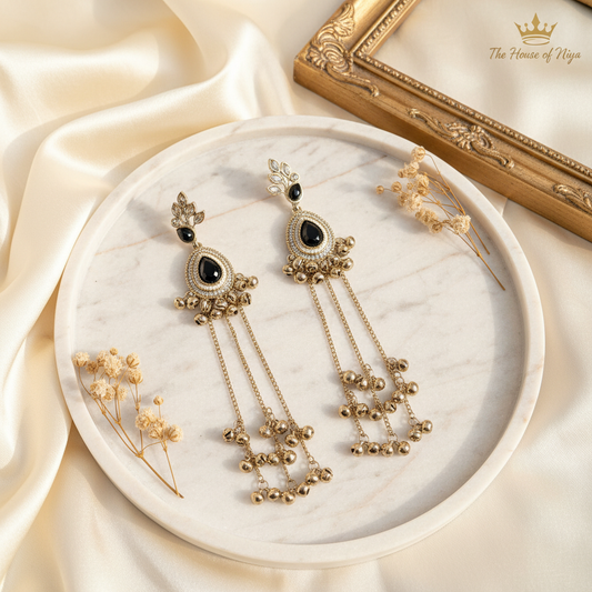 Black onyx ghungroo tassel drop earrings on marble tray
