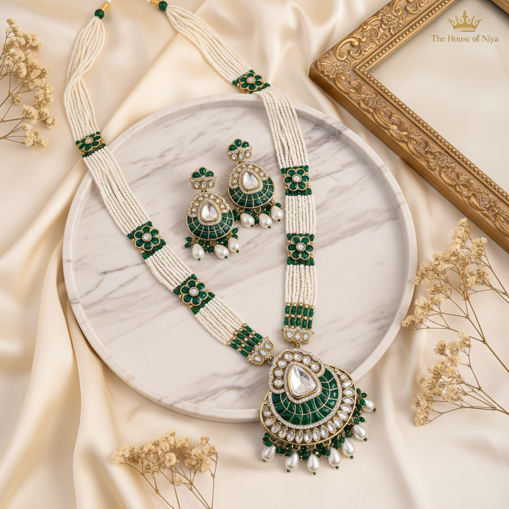 Emerald green polki long necklace and earring set on marble tray