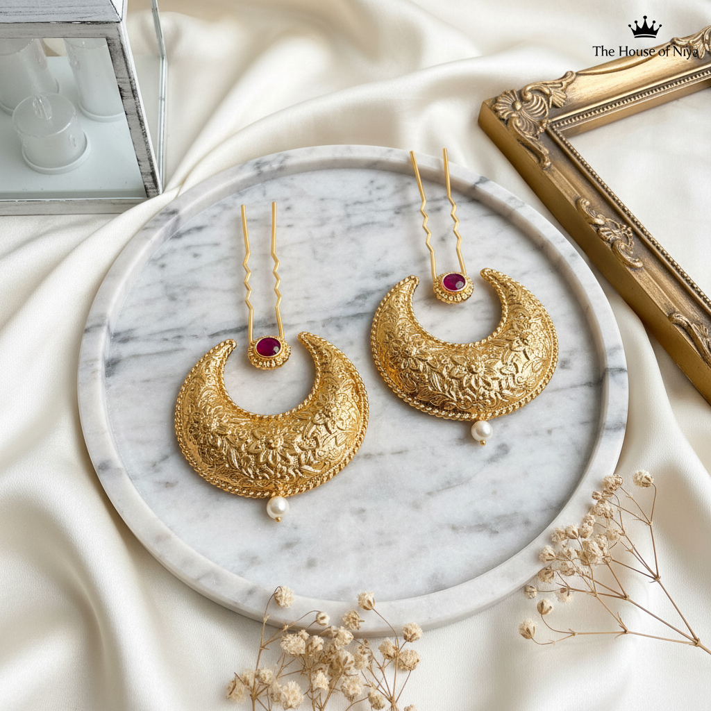 Gold crescent moon filigree hair pins on marble tray